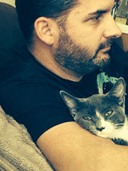 Happy adopted gray and white rescue cat in home